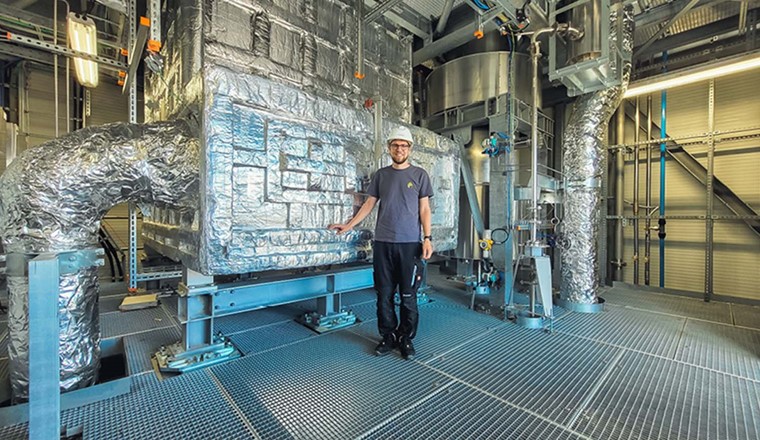 Lukas Geissbühler, Head Thermal Systems bei Synhelion, vor dem Hochtemperatur-Wärmespeicher von «DAWN». (Bild: Synhelion)